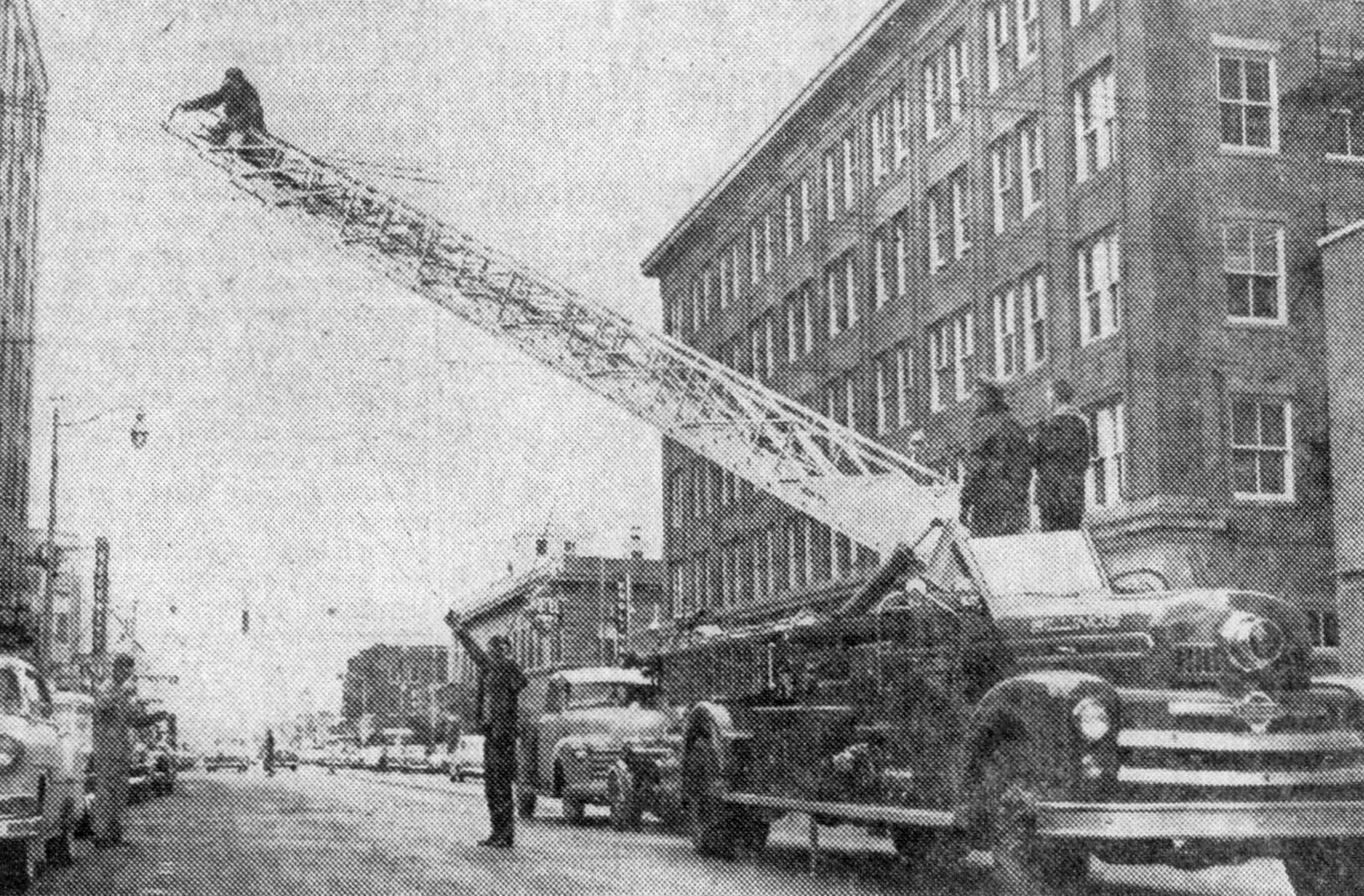 Firefighters hanging Christmas decorations, 1953